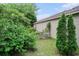 Landscaped backyard with a charming white picket fence and flourishing greenery near the home's exterior wall at 6006 Quinn Rd., Myrtle Beach, SC 29579