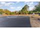 Community basketball court in a park-like setting with mature trees and a bench at 6006 Quinn Rd., Myrtle Beach, SC 29579