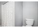 Simple bathroom with a toilet and patterned shower curtain at 6006 Quinn Rd., Myrtle Beach, SC 29579