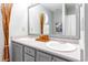 Well-lit bathroom with double sinks, neutral decor, and a large mirror at 6006 Quinn Rd., Myrtle Beach, SC 29579