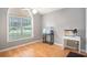 Bedroom with a window offering natural light, complemented by wood floors and neutral walls at 6006 Quinn Rd., Myrtle Beach, SC 29579