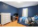 Comfortable bedroom featuring blue walls and a wood floor, providing a cozy and inviting space at 6006 Quinn Rd., Myrtle Beach, SC 29579