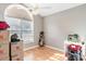 Bright, empty bedroom with wood floors and a ceiling fan; ready for customization at 6006 Quinn Rd., Myrtle Beach, SC 29579