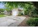 Home exterior featuring an attached garage, a paved driveway, and mature landscaping at 6006 Quinn Rd., Myrtle Beach, SC 29579
