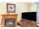 Close-up of a charming fireplace with decorative mantle and a large television at 6006 Quinn Rd., Myrtle Beach, SC 29579