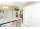 Kitchen area with stainless appliances, tile flooring, granite countertops and view to fireplace at 6006 Quinn Rd., Myrtle Beach, SC 29579