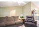 Living room showcasing a leather recliner, plush sofa, and access to the kitchen at 6006 Quinn Rd., Myrtle Beach, SC 29579
