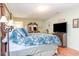 Light bedroom with a four poster bed and floral comforter, wood floors, and decor at 6006 Quinn Rd., Myrtle Beach, SC 29579
