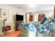 Spacious bedroom with a floral-patterned comforter, wood floors, and stylish furnishings at 6006 Quinn Rd., Myrtle Beach, SC 29579