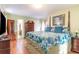 Bright main bedroom with a floral comforter, wood floors, and stylish furnishings at 6006 Quinn Rd., Myrtle Beach, SC 29579