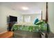 Cozy main bedroom with a four poster bed, hardwood floors, and ample natural light at 6006 Quinn Rd., Myrtle Beach, SC 29579