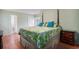 Cozy main bedroom with a four poster bed, hardwood floors, and ample natural light at 6006 Quinn Rd., Myrtle Beach, SC 29579