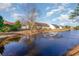 Scenic view of a pond with fountain feature behind homes in a residential neighborhood at 6006 Quinn Rd., Myrtle Beach, SC 29579