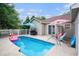 Backyard pool with a fence, umbrella and patio, perfect for outdoor gatherings and relaxation at 6006 Quinn Rd., Myrtle Beach, SC 29579