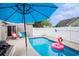 Inviting backyard pool with lounge chairs, an umbrella, and a fun flamingo floatie at 6006 Quinn Rd., Myrtle Beach, SC 29579
