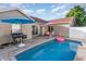 Backyard pool with a patio, seating, grill and flamingo floatie, perfect for outdoor entertainment at 6006 Quinn Rd., Myrtle Beach, SC 29579