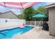 Backyard pool with a flamingo floatie, surrounded by a patio and white privacy fence at 6006 Quinn Rd., Myrtle Beach, SC 29579