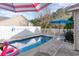 A backyard pool with white fencing, lounge chairs, and umbrella, perfect for summer fun and relaxation at 6006 Quinn Rd., Myrtle Beach, SC 29579