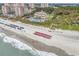 Aerial view of beach and beachfront condos and clubhouse with pools and ocean views at 6069 Tramonto St., Myrtle Beach, SC 29572