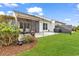 The house featuring a screened-in porch, patio, and well-manicured lawn at 6069 Tramonto St., Myrtle Beach, SC 29572