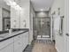 Modern bathroom with double vanity, tile floors, and a glass-enclosed shower at 6069 Tramonto St., Myrtle Beach, SC 29572