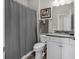 Cozy bathroom featuring a shower with a gray curtain, sleek vanity, and ceramic tile flooring at 6069 Tramonto St., Myrtle Beach, SC 29572