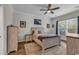 A bright bedroom featuring a ceiling fan, and a large window that allows natural light to illuminate the space at 6069 Tramonto St., Myrtle Beach, SC 29572