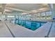 Bright indoor pool with lap lanes, natural light, and blue and white pennant decorations at 6069 Tramonto St., Myrtle Beach, SC 29572