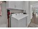 Bright laundry room with white cabinetry, ceramic tile flooring, and modern washer and dryer at 6069 Tramonto St., Myrtle Beach, SC 29572