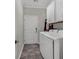 Functional laundry room with white cabinets, modern washer, and dryer on ceramic tile flooring at 6069 Tramonto St., Myrtle Beach, SC 29572