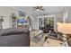 A cozy living room featuring a ceiling fan, TV, and sliding glass doors to the porch at 6069 Tramonto St., Myrtle Beach, SC 29572