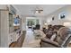 Comfortable living room with a ceiling fan, neutral walls, wood flooring, and sliding glass doors to the porch at 6069 Tramonto St., Myrtle Beach, SC 29572