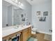 Bathroom featuring a spacious vanity, framed mirror, and marine-themed decor, with tile flooring at 6203 Catalina Dr. # 2316, North Myrtle Beach, SC 29582