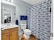 Bathroom with a fish-themed shower curtain, wooden vanity, and nautical decor at 6203 Catalina Dr. # 2316, North Myrtle Beach, SC 29582
