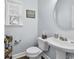 Cozy half bath featuring wood floors, a pedestal sink, and natural light from the window at 6203 Catalina Dr. # 2316, North Myrtle Beach, SC 29582
