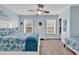 Bright bedroom with white furniture, two beds, and a light blue accent wall with windows at 6203 Catalina Dr. # 2316, North Myrtle Beach, SC 29582