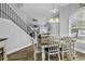 Bright dining room features wood flooring, a modern chandelier, and a view into the adjacent living area at 6203 Catalina Dr. # 2316, North Myrtle Beach, SC 29582