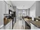 Bright kitchen features tile floors, neutral color scheme, updated appliances, and breakfast bar at 6203 Catalina Dr. # 2316, North Myrtle Beach, SC 29582