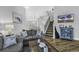Inviting living room showcasing hardwood flooring and a view into the dinning room and stair case at 6203 Catalina Dr. # 2316, North Myrtle Beach, SC 29582