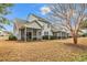 Charming rear exterior view of a home featuring multiple screened porches and a well-maintained yard at 6203 Catalina Dr. # 2316, North Myrtle Beach, SC 29582