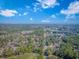 Aerial view displays the town with golf course, trees, and distant water at 67 Massick Ln., Pawleys Island, SC 29585