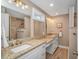 Bright bathroom with double sink vanity, granite countertops, and a decorative mirror at 67 Massick Ln., Pawleys Island, SC 29585