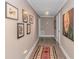 The hallway leads to a carpeted hallway adorned with tasteful artwork at 67 Massick Ln., Pawleys Island, SC 29585