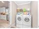 Well-lit laundry room includes front-loading washer and dryer, plus shelving for storage at 67 Massick Ln., Pawleys Island, SC 29585