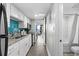 Galley kitchen with white cabinets, stainless steel appliances, and open access to the ocean-view balcony at 7200 N Ocean Blvd. # 662, Myrtle Beach, SC 29572