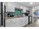 Well-equipped kitchen with granite counters, white cabinets, and modern appliances at 7200 N Ocean Blvd. # 662, Myrtle Beach, SC 29572