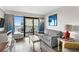 Bright living room with a sofa, balcony access, and beach view, complemented by modern furnishings at 7200 N Ocean Blvd. # 662, Myrtle Beach, SC 29572