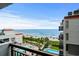 Balcony view overlooking the beach and ocean, with multiple pools and palm trees lining the shore at 7200 N Ocean Blvd. # 662, Myrtle Beach, SC 29572