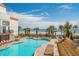 Beautiful outdoor pool and patio with lounge chairs, palm trees, and ocean views at 7200 N Ocean Blvd. # 662, Myrtle Beach, SC 29572