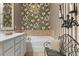 Elegant bathroom showcases stylish wallpaper, a tub, and a chandelier for a spa-like experience at 730 Pickering Dr. # 201, Murrells Inlet, SC 29576